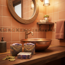 Bathroom with copper sink, soap, and towel on wooden counter