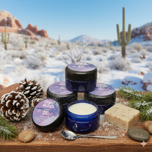 Chac mool hand creme against a snowy desert backdrop on a wooden plank surrounded by pinecones and pine boughs