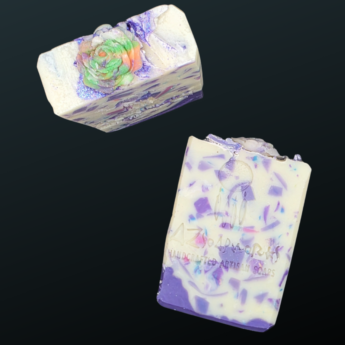 Two bars of soap with a colorful design on a black background

